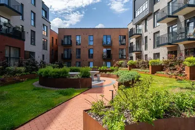 a courtyard in an apartment complex with buildings at Paupys lofts in Vilnius