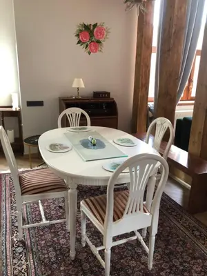 a white dining room table with four chairs at Boutique Studija Žibutė in Panevėžys
