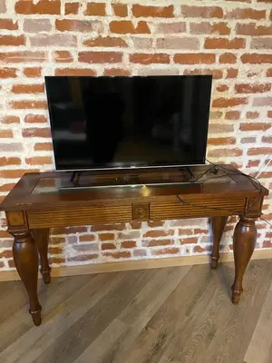 a flat screen tv sitting on top of a wooden table at Boutique Studija Žibutė in Panevėžys