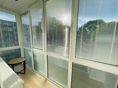 a room with large windows with blinds on them at LilHouse Apartment in Siauliai Center in Šiauliai