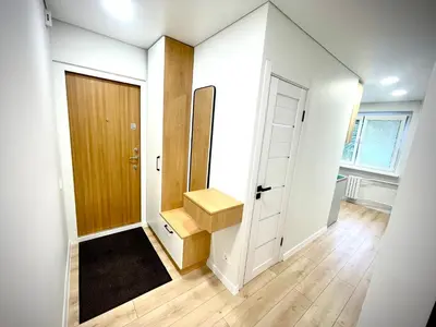 a bathroom with a sink and a wooden door at LilHouse Apartment in Siauliai Center in Šiauliai