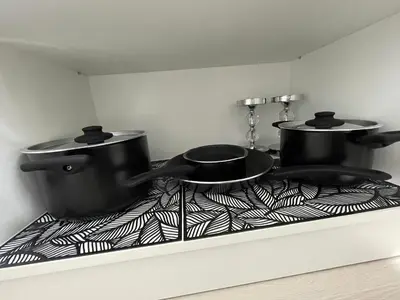 two pots and pans sitting on top of a stove at Radvilų apartamentai in Radviliškis