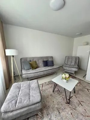 a living room with a couch and a coffee table at Radvilų apartamentai in Radviliškis