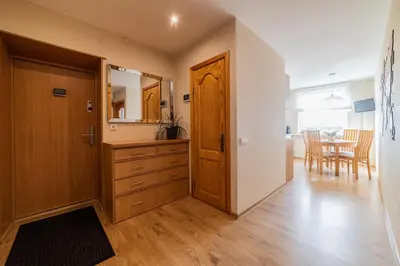 a kitchen with a dresser and a dining room at E D Arena View Apartment in Šiauliai