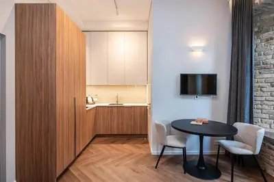 a small room with a table and chairs and a kitchen at Art Boutique I Old Town Apartments w-AC I cohost in Vilnius