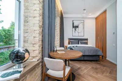 a bedroom with a bed and a table and a table sidx sidx sidx at Art Boutique I Old Town Apartments w-AC I cohost in Vilnius