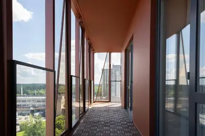 an empty corridor in a building with glass windows at VIXI Skylum in Vilnius