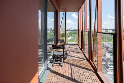 a balcony with chairs and a view of the city at VIXI Skylum in Vilnius