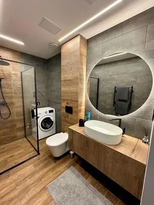 a bathroom with a sink and a toilet and a mirror at Budiniškiu apartamentai in Vilnius