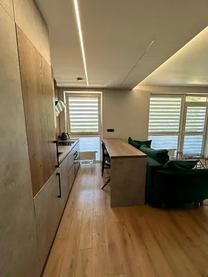 a living room with a table and a couch at Budiniškiu apartamentai in Vilnius