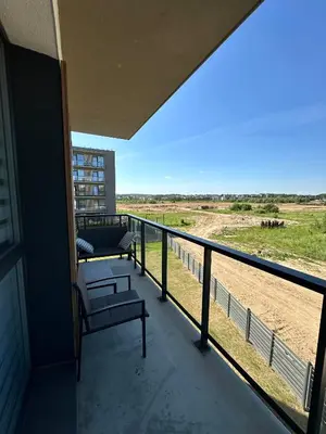 a balcony with a bench and a view of a field at Budiniškiu apartamentai in Vilnius
