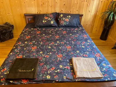 a bed with two books sitting on top of it at Malinada-kaimo sodyba in Šalčininkai