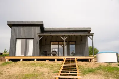 a tiny house on top of a hill with a ramp at Pineplace trio KOPA in Žaugėdai