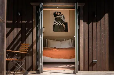 an open door to a bedroom with a bed at Kupetaite - Straw Bale Cabin in Nature in Družai