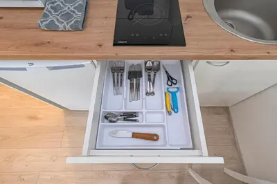 a refrigerator with its door open with tools in it at Partizanų studio apartment #3 by Polo Apartments in Kaunas