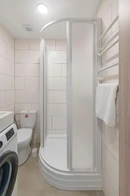 a shower in a bathroom with a toilet at Partizanų studio apartment #3 by Polo Apartments in Kaunas