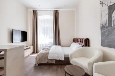 a hotel room with a bed and a chair at StudioApart23 in Vilnius