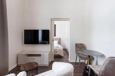 a living room with a tv on a wall at StudioApart23 in Vilnius