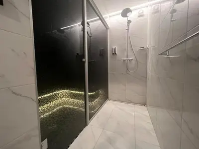 a bathroom with a shower with a glass door at Kepezinski SPA apartments in Kaunas