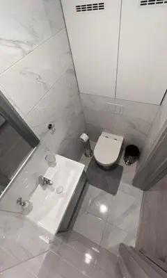 a white bathroom with a sink and a toilet at Kepezinski SPA apartments in Kaunas