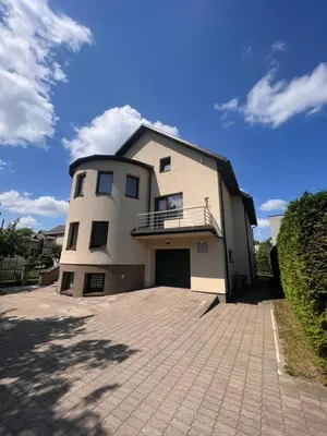 a large white house with a large driveway at Kepezinski SPA apartments in Kaunas