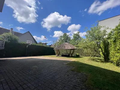 a garden with a gazebo in a yard at Kepezinski SPA apartments in Kaunas