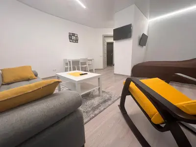 a living room with a couch and a table at Kepezinski SPA apartments in Kaunas