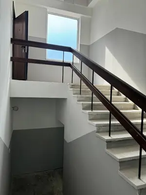a staircase in a house with a window at PLENTO g APARTAMENTAI BIRŽUOSE in Biržai