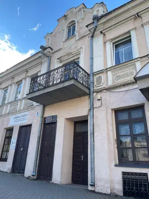 a building with a balcony on the side of it at Vilkmerge apartment in Ukmergė