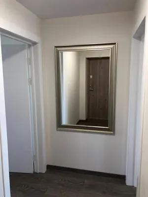 a mirror on a wall in a room at TWIX dvi skirtingos gretimos erdvės in Birštonas