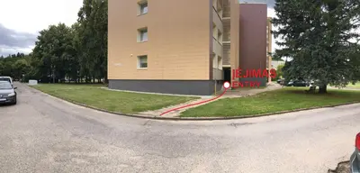 a building with a red curb next to a street at TWIX dvi skirtingos gretimos erdvės in Birštonas