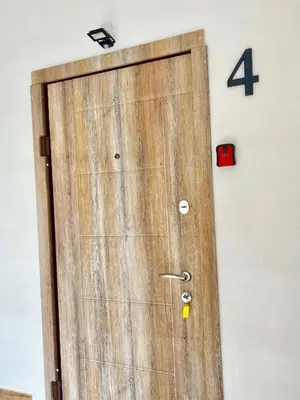 a wooden door with a number four on a wall at Gedimino 19 apartments in the old town of Ukmergė in Ukmergė