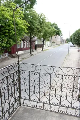 an iron gate on a street in a residential neighborhood at Gedimino 19 apartments in the old town of Ukmergė in Ukmergė