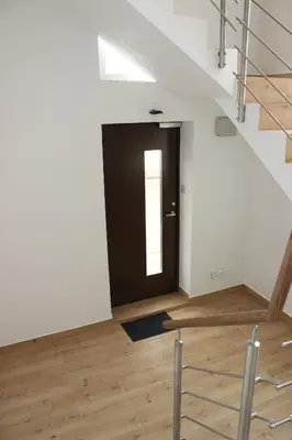 a room with a black door and a wooden floor at Gedimino 19 apartments in the old town of Ukmergė in Ukmergė