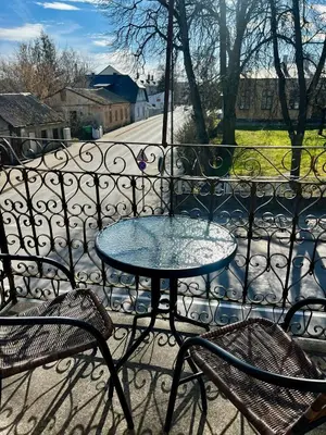 a table and two chairs on a balcony at Gedimino 19 apartments in the old town of Ukmergė in Ukmergė