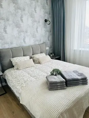 a bedroom with a bed with two pillows on it at Žaliakalnis Suites in Kaunas
