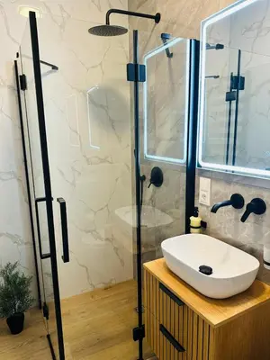 a bathroom with a sink and a shower at Žaliakalnis Suites in Kaunas