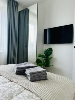 a bedroom with a bed with towels on it at Žaliakalnis Suites in Kaunas