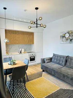 a living room with a couch and a table at Žaliakalnis Suites in Kaunas