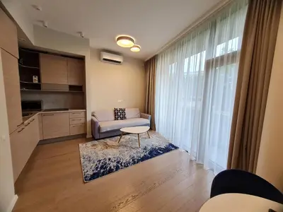 a living room with a couch and a table at Saulės Muzika in Druskininkai