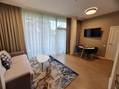 a living room with a couch and a table at Saulės Muzika in Druskininkai