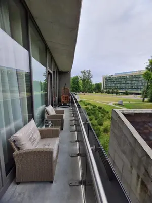 a balcony of a building with couches on it at Saulės Muzika in Druskininkai