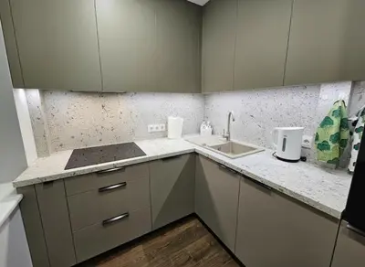 a kitchen with white cabinets and a sink at Trakai City apartment 2-bedroom in Šiauliai