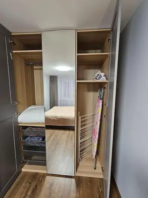 a room with a closet with a bed in it at Trakai City apartment 2-bedroom in Šiauliai