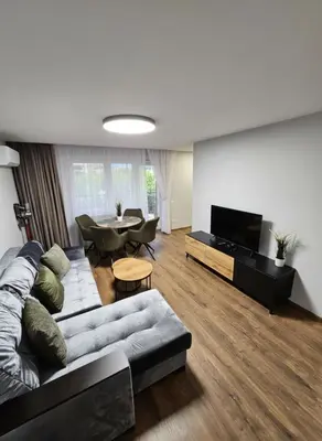 a living room with a couch and a table at Trakai City apartment 2-bedroom in Šiauliai