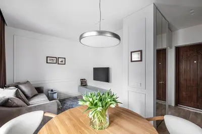 a living room with a table and a couch at Feels like home - Jauku kaip namuose in Kaunas
