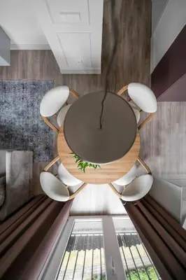 a circular table and chairs in a room at Feels like home - Jauku kaip namuose in Kaunas