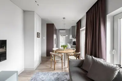 a living room with a couch and a table at Feels like home - Jauku kaip namuose in Kaunas