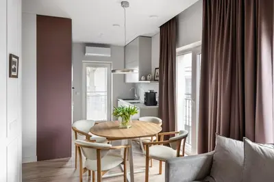 a dining room with a table and chairs at Feels like home - Jauku kaip namuose in Kaunas