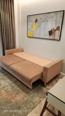 a bed in a room with a painting on the wall at HaPPy iNN Brilliant Old Town self check in, Underground Parking, Terrace in Vilnius